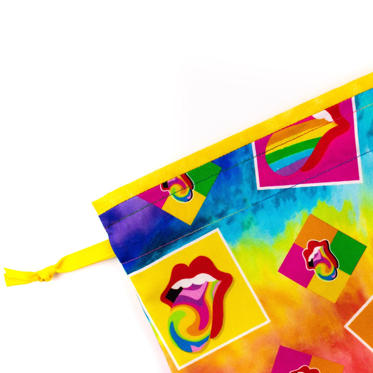 Close-up of shoe bag showing graphics of red lips with rainbow-colored tongues