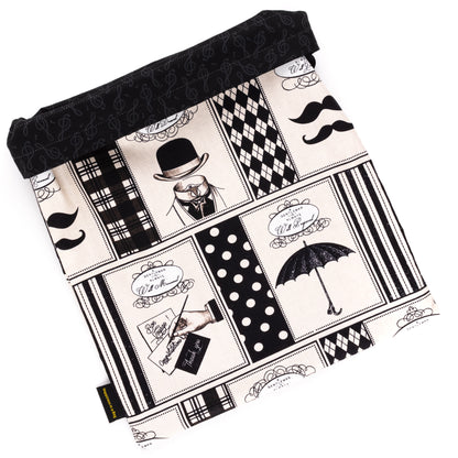 Black and beige shoe bag with drawings of umbrellas and top hats