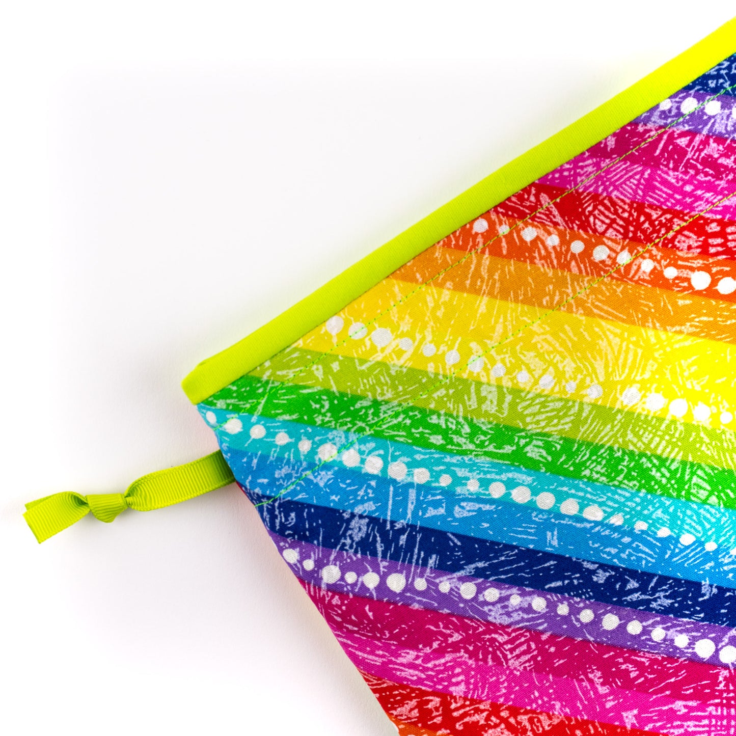 Close up of fabric shoe bag in diagonal rainbow stripes fabric