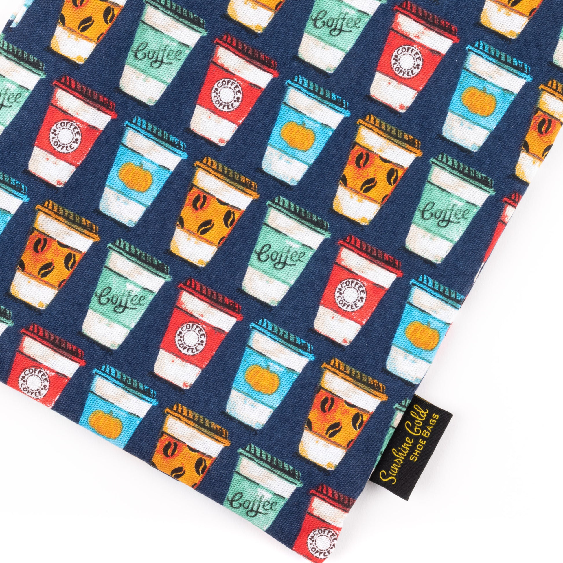 Close up of fabric shoe bag in red, blue, and orange fabric with coffee-cup prints