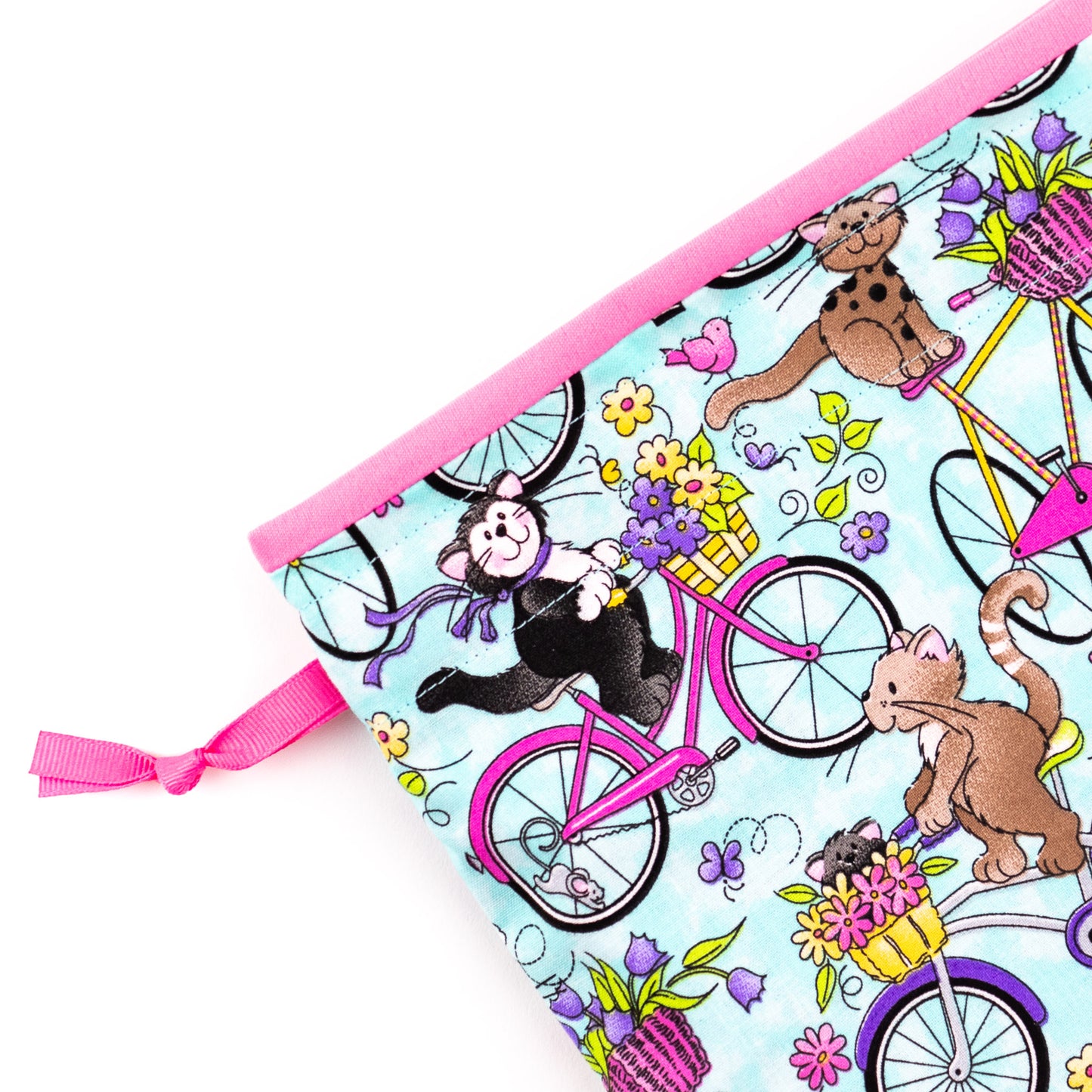 Close-up of fabric shoe bag in vibrant cats on bikes themed fabric