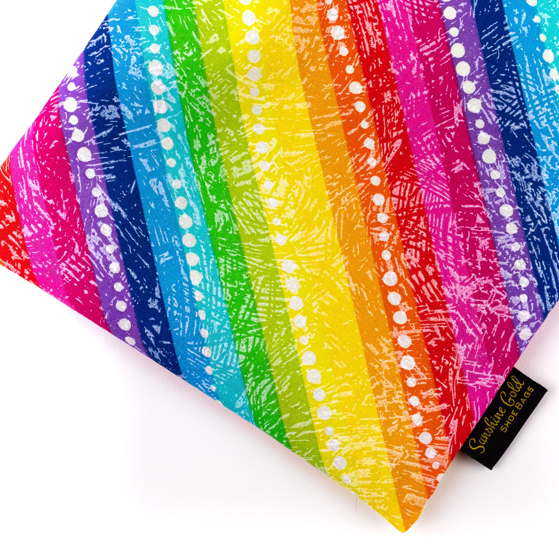 Close up of travel shoe bag with rainbow-colored stripes on the fabric and lime-green lining