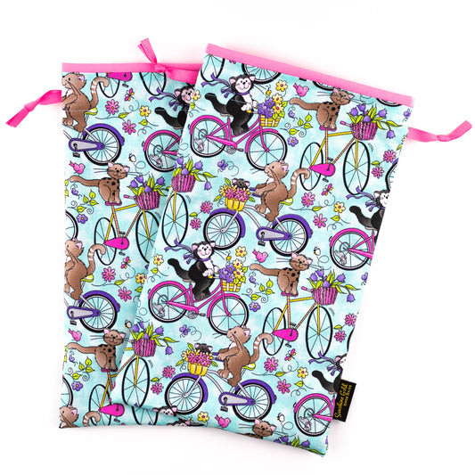 Travel shoe bags from colorful fabric showing cats riding bikes